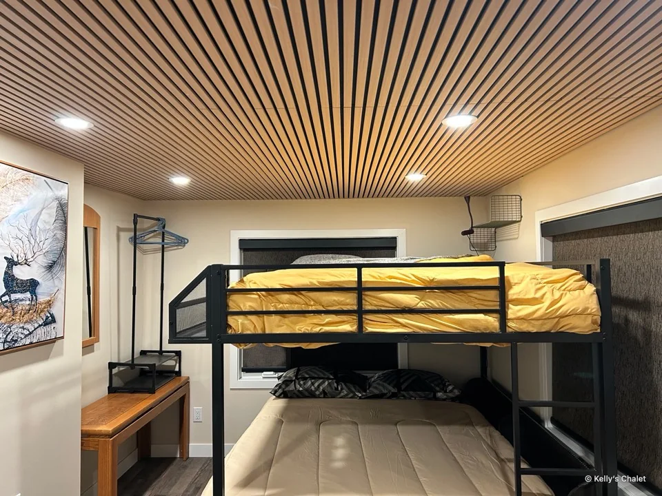 Bunk beds beneath a slatted timber ceiling in the main bedroom