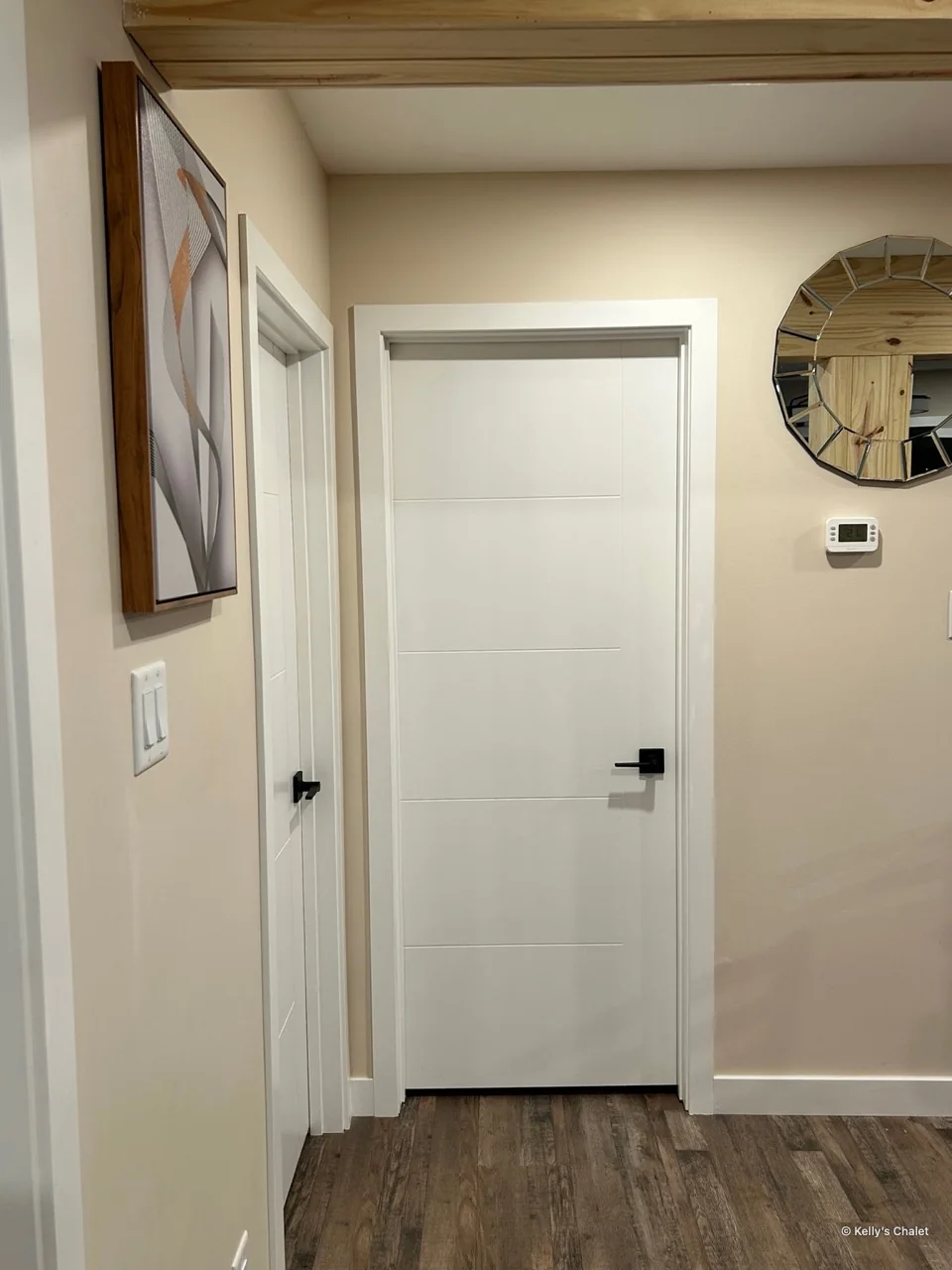 A clean hallway view toward the chalet’s washroom entrance