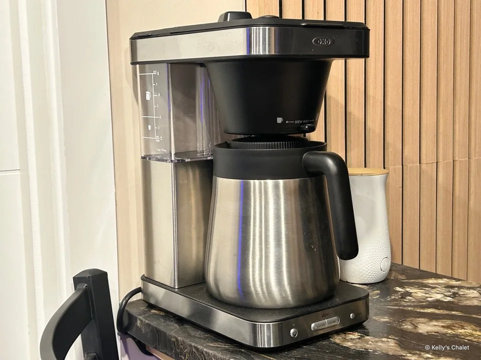 Closer view of the coffee maker on the patterned countertop