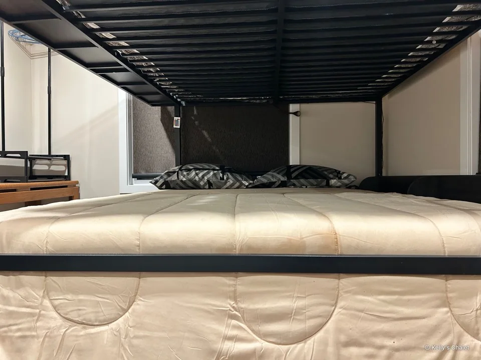 A closer view of the lower bunk and bedding in the main bedroom