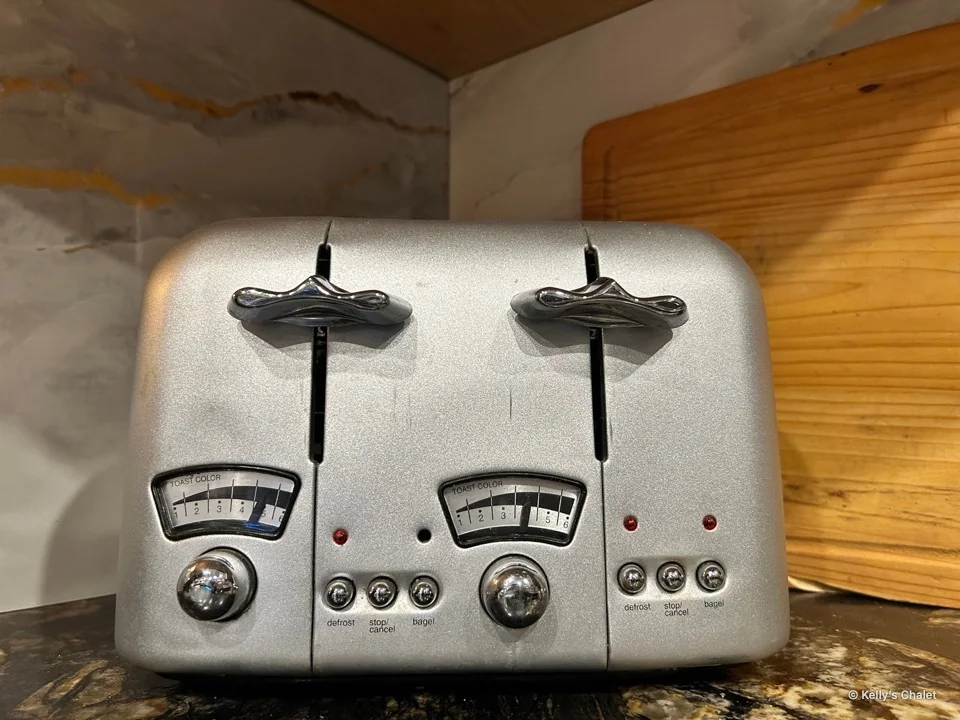 Four slice toaster beside a wooden board on the kitchen counter