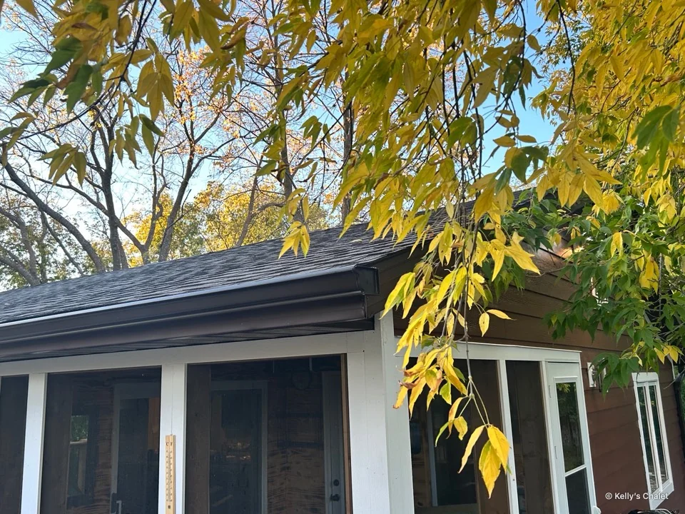 Golden leaves hanging over the chalet’s porch roof