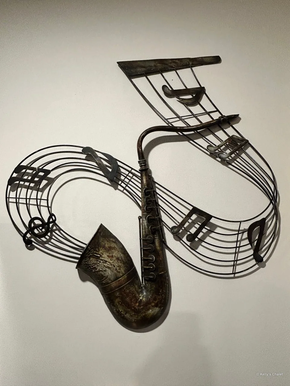 Metal saxophone and musical note wall artwork in the chalet