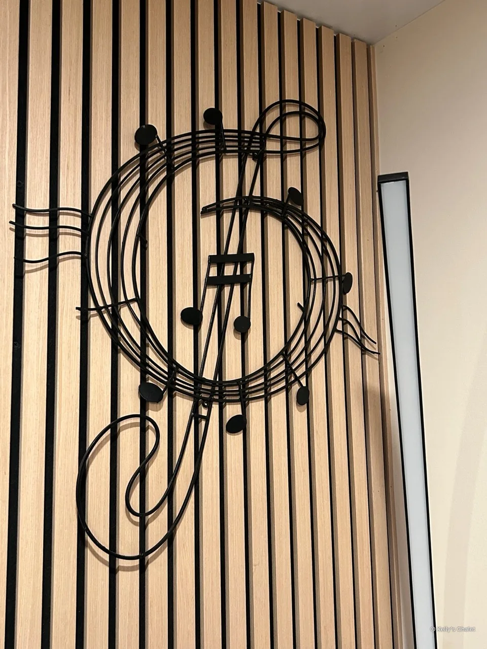 A treble clef wall ornament against the chalet’s timber feature wall